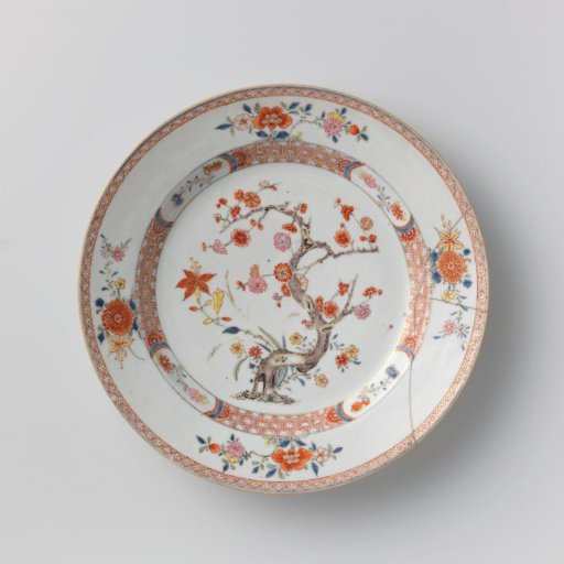 Dish with a flowering prunus tree and flowering plants