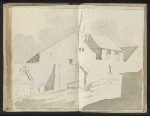Spire between houses on an unpaved road