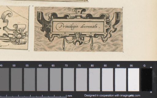 Small cartouche with scrollwork and a mask