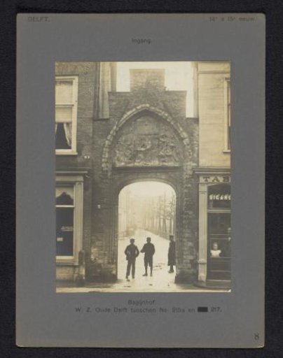 Entrance gate to the Beguinage in Delft with three people