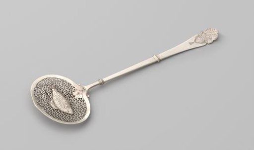 Fish scoop with a fish on the scoop against a pierced background of rosettes