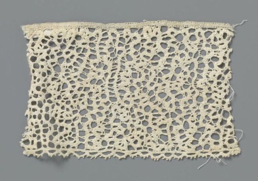 Strip of bobbin lace with tangled ribbon pattern