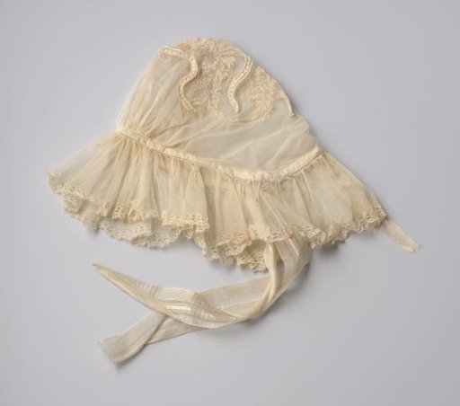 Cap of machine-made tulle decorated with appliqué and motifs, trimmed with a strip of Brussels lace