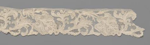 Strip of needle lace with iris on an S-shaped stem with a knot