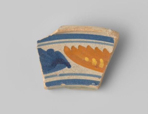 Fragment of a plate with a reddish-firing sherd, with white glaze on the front and back, decorated on the front with stripes and leaf-like forms in orange, yellow and blue
