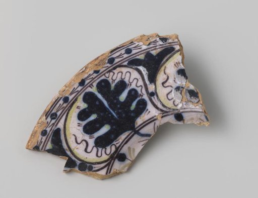 Fragment of a plate with a yellow-firing sherd, with light pink glaze on the front and back, decorated on the front with floral forms in purple, dark blue and yellow glaze