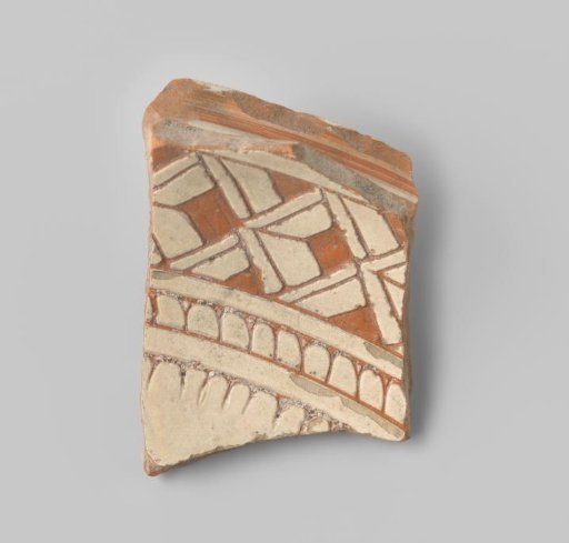 Plate fragment with red-fired body, with floral and geometric forms in white glaze in sgraffito technique on the front and back