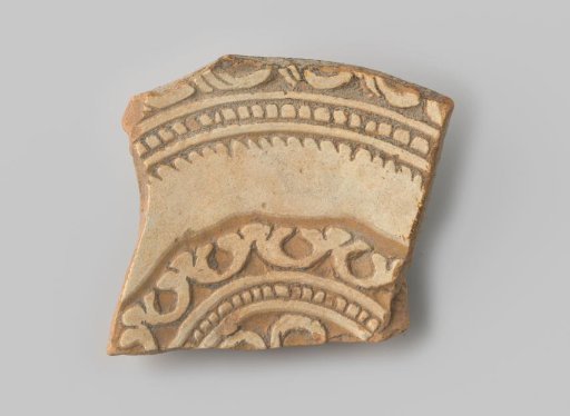 Sherd of red-fired earthenware, decorated on the front with various borders in sgraffito technique with white glaze, unglazed on the back