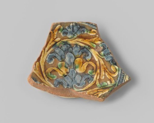 Fragment (foot) with red sherd, with a decoration of floral forms in blue, yellow, and green on the upper side