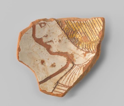 Fragment (foot) with red sherd, in sgraffito technique a man's head turned to the left (?) with ochre-coloured long hair; the outer drawing has a broad, incised outline, of lesser quality