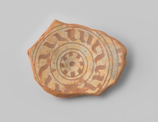 Fragment of red-fired earthenware with a foot ring, with a geometric relief pattern and white glaze on the upper side, unglazed on the underside