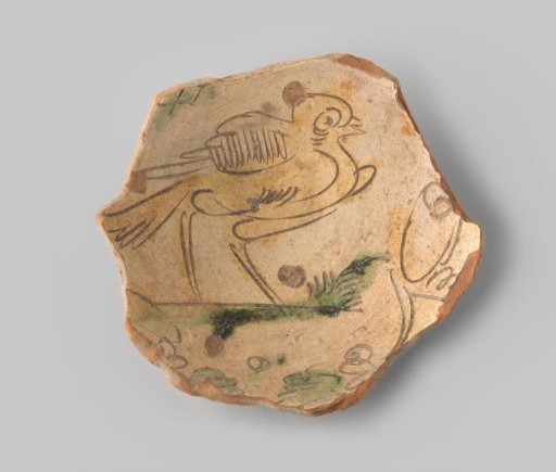 Fragment (foot) with red sherd, on the inside in sgraffito technique a bird in ochre on a green branch, on a beige ground