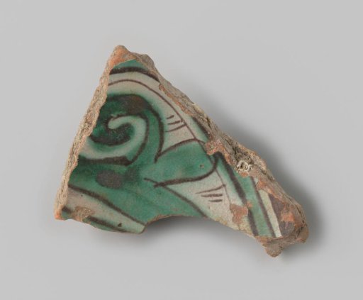 Sherd of red-fired earthenware, decorated on the front with white glaze featuring a leaf shape in green and black, unglazed on the back