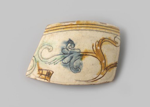 Sherd of red-firing earthenware, decorated on the inside and outside with leafy scrolls in sgraffito technique with green, yellow, and blue glaze on a white ground