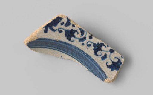 Fragment of white-fired earthenware, glazed colorless on the front and back with a decoration in blue glaze