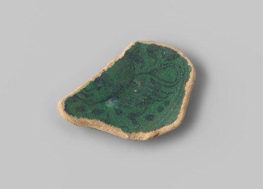 Fragment (foot) with grey-yellow sherd, on dark green glaze a drawing in black of an angel's head with wings (one visible) and tendrils