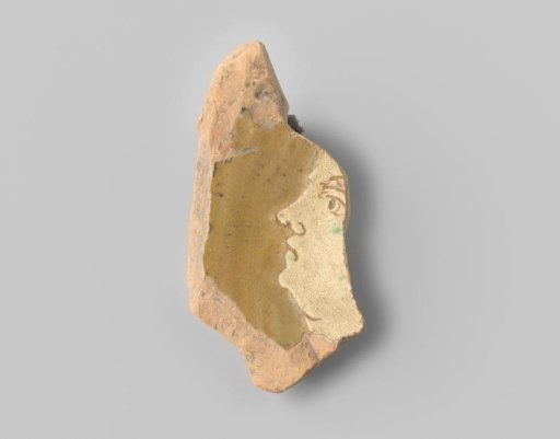 Fragment (foot) with reddish sherd, in sgraffito technique a white woman's head on a beige ground