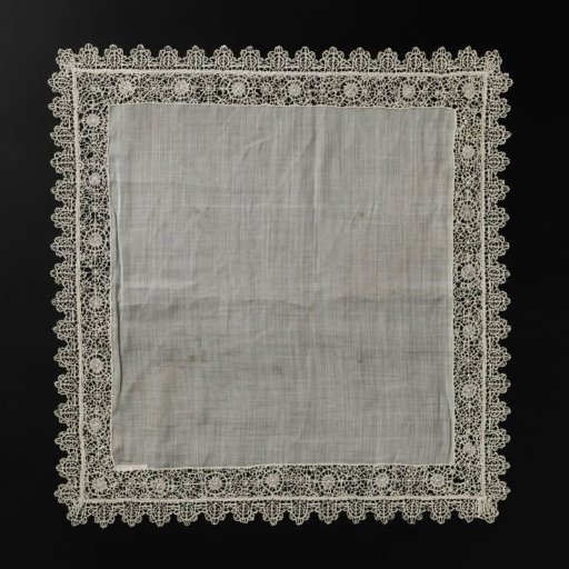 Handkerchief of net fabric bordered by reticella inserts and edged with bobbin lace