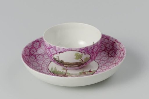 Cup and saucer with a multicoloured landscape in a medallion cut out in a geometric pattern
