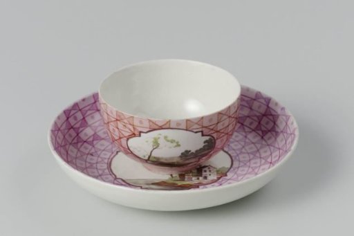 Cup and saucer with a multicoloured landscape in a medallion cut out in a geometric pattern
