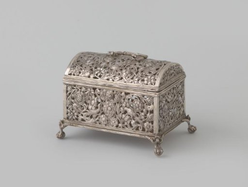 Silver knot chest with openwork walls with flowers and birds, on four claw feet and with handle with dragons.