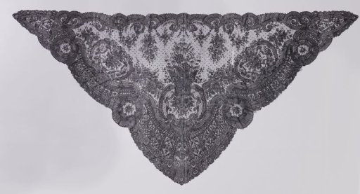 Shawl of black bobbin lace with a central medallion of C-scrolls and a border with round medallions with a hexagonal heart