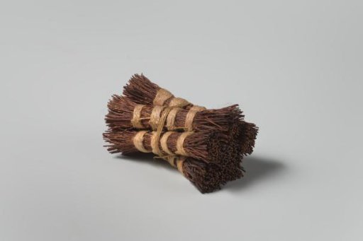 Broom, tied with pink thread