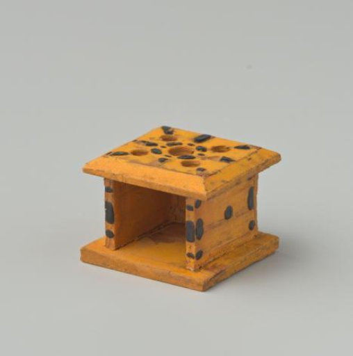 Stove, yellow in color, decorated with black dots