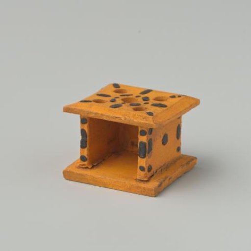 Stove, yellow in color, decorated with black dots