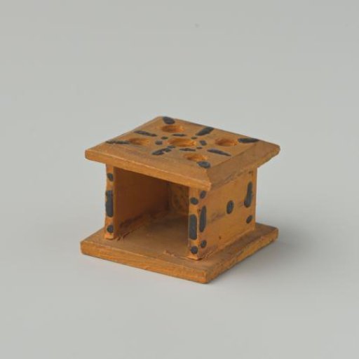 Stove, yellow in color, decorated with black dots
