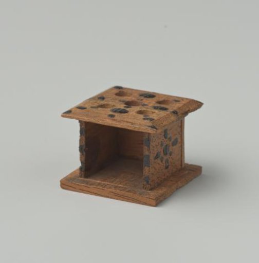 Stove of walnut wood, decorated with black dots