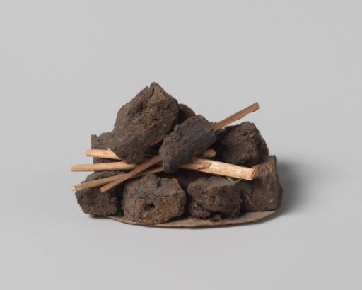 Peat blocks, stacked on a piece of paper
