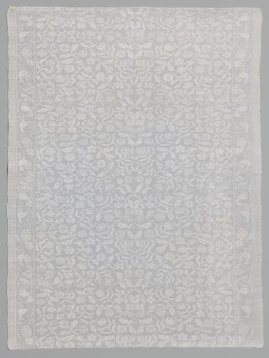 Mirrored floral pattern. Border: winding floral vine with birds and a block border.