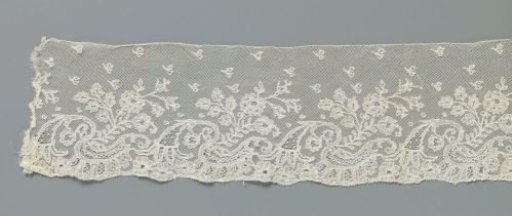 Strip of bobbin lace with rose branch from ornamental band with horn of plenty