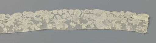 Strip of bobbin lace with a flowerpot with one rosette flower on a long stem