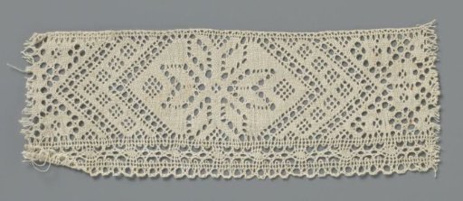 Strip of bobbin lace with star-shaped flower cut out in a flattened hexagonal field