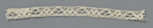 Strip of bobbin lace with a continuous row of circles and trapezoidal fields