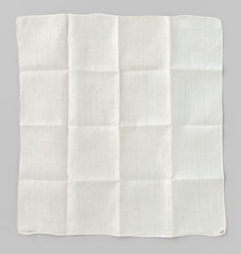 White linen napkin with woven floral motif
