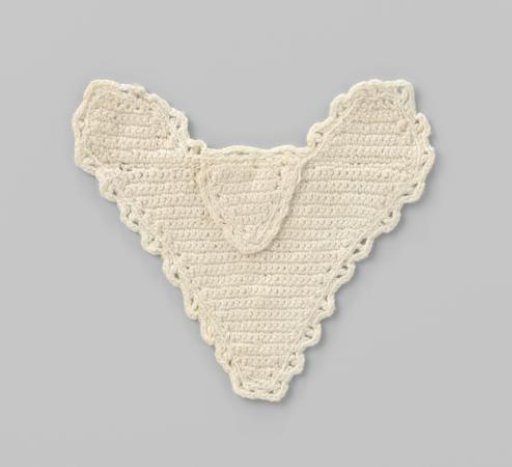 Heart-shaped knitted white cotton pinafore for doll