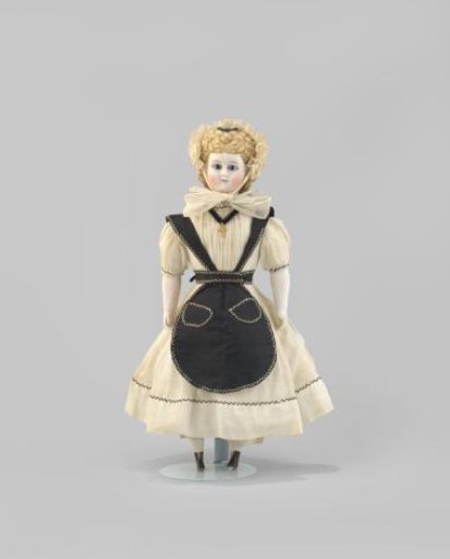 Doll with a porcelain head and blonde hair with black boots
