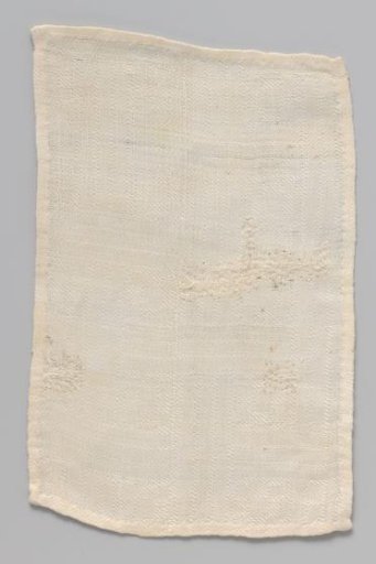 White rectangular cloth with woven geometric pattern