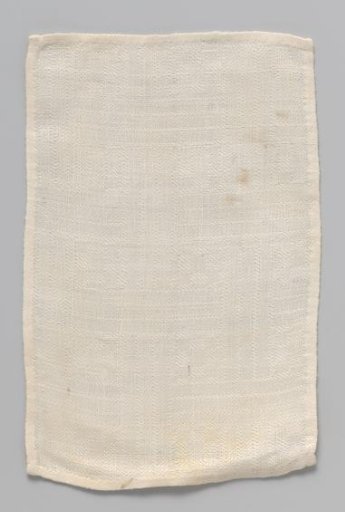 White rectangular cloth with woven geometric pattern