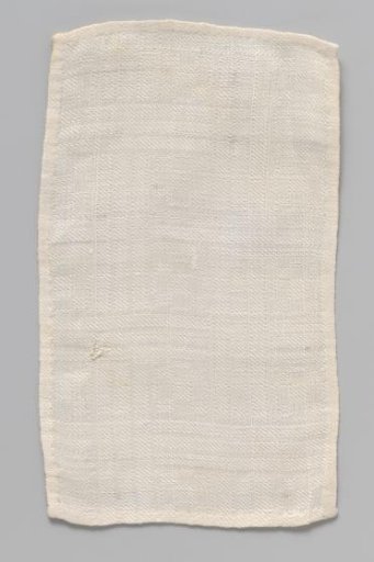 White rectangular cloth with woven geometric pattern