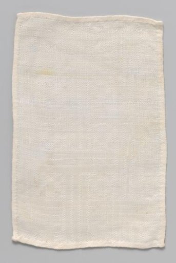 White rectangular cloth with woven geometric pattern