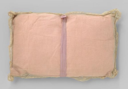 Rectangular cushion, of pink textile, with lace cover
