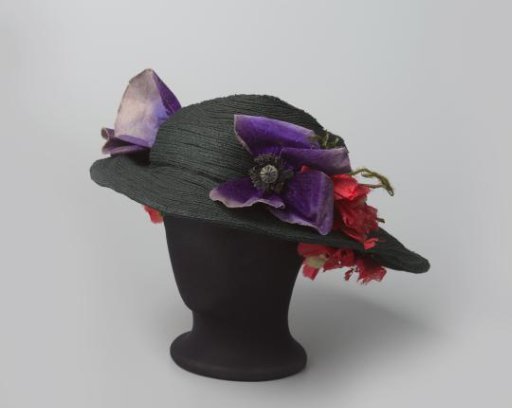 Hat of black braided straw decorated with flowers