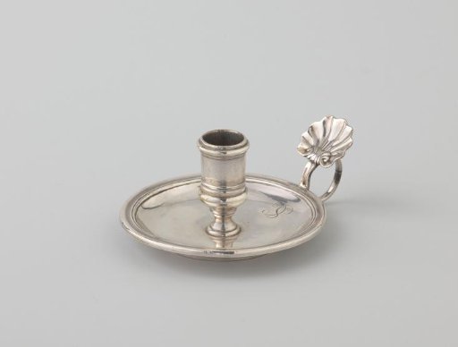 Salver. A round plate with a profiled rim, with a candlestick in the center and a volute-shaped handle along the edge.