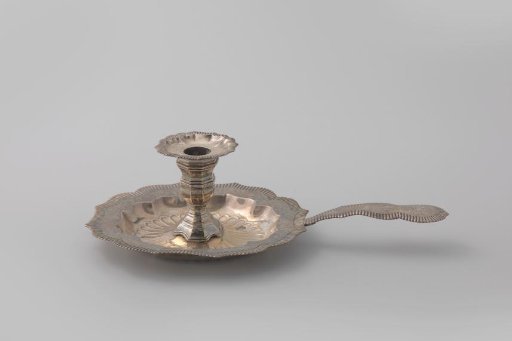 Silver sugar caster, leaf-shaped with a long stem, finished with a ribbed border containing engraved vines on a granulated ground