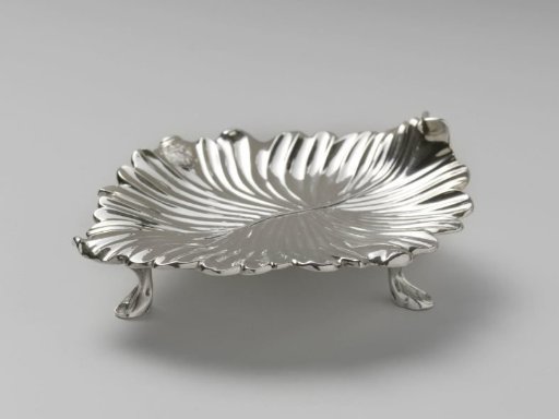 Dish (?) in the form of a leaf on three stump-like feet. With engraved coat of arms.