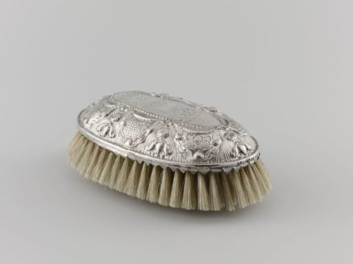 Brush with oval back in silver